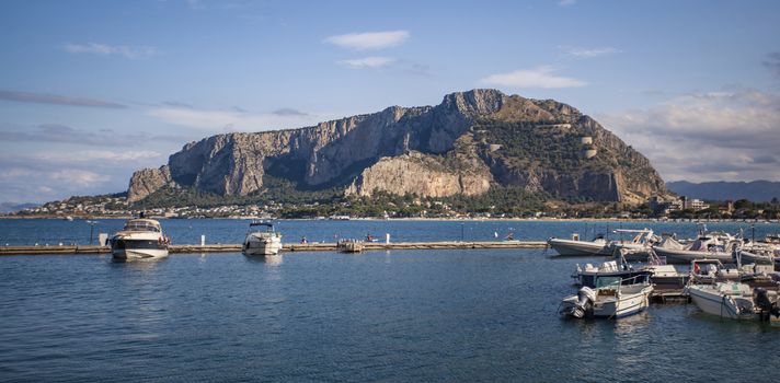 View of Mondello where you can see sea boats and the whole panorama in the background.