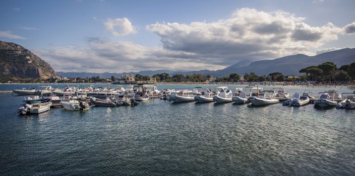 View of Mondello where you can see sea boats and the whole panorama in the background.