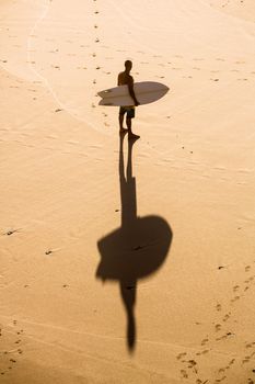 Top view of a surfer on the beach