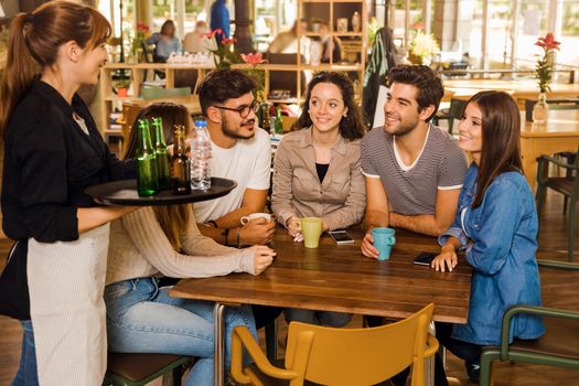 A group of friends making a order at cafe 