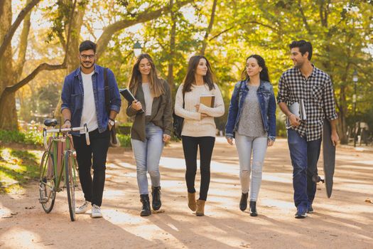 Group of students walking together in the park