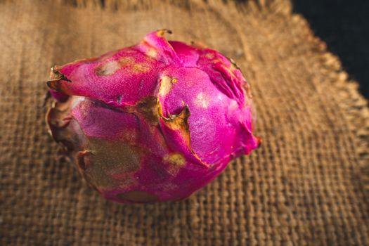 A Dragon Fruit. Tropical Fruits. On a wooden background. Top view. Copy space.