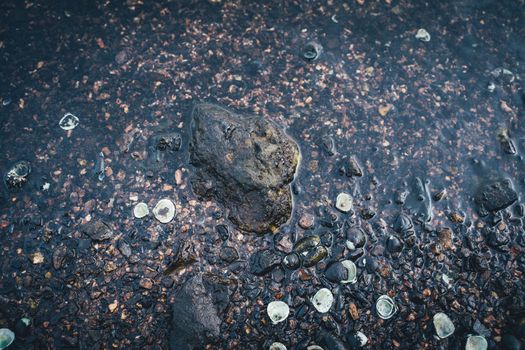 The Small stones by the sea with bokeh effect. Blurred decorative background