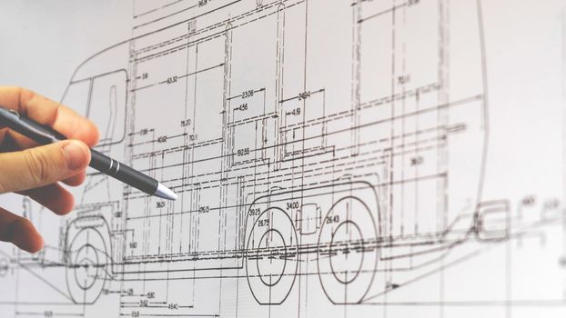 blueprint monitor of a hand with pen explain plan of a van vehicle on the screen in Bologna, Italy, 22 Sep 2019