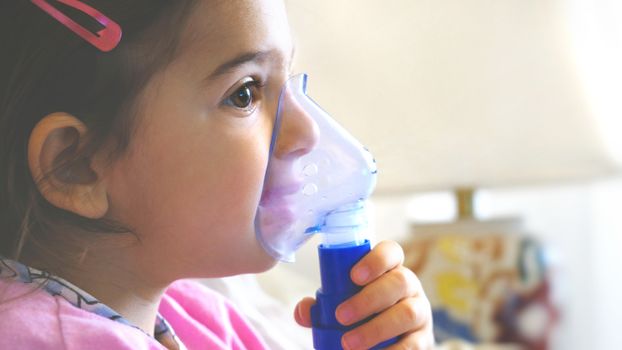 childhood asthma inhaling mask illnesses little baby girl with flu id doing aerosol independently .