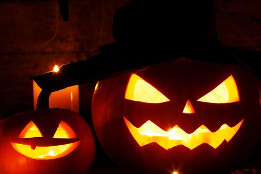 Jack O Lantern Halloween pumpkin with witches hat, spiders on web and burning candles