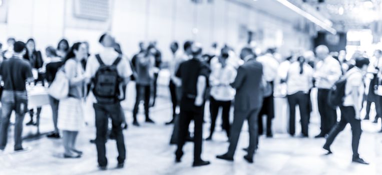 Blured image of businesspeople at coffee break at conference meeting. Business and entrepreneurship. Blue toned grayscale image.