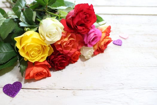 The pictureshows colorful roses with hearts.