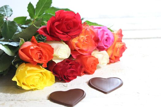 The picture shows colorful roses with hearts.