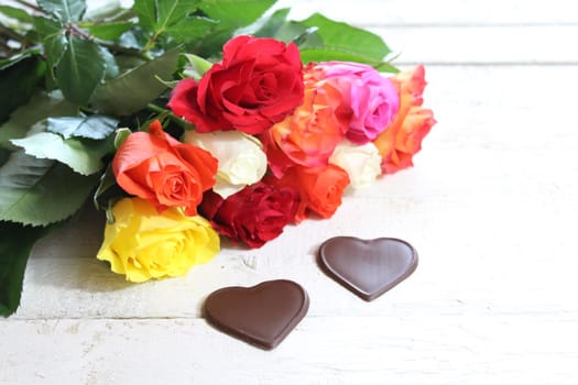 The picture shows colorful roses with hearts.