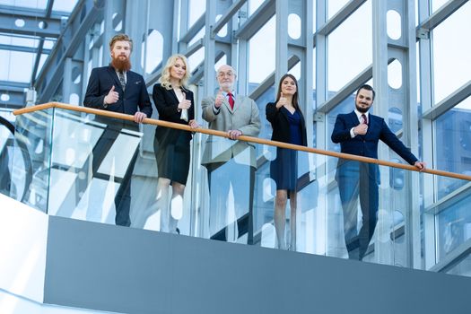 Successful positive group of business men and women giving thumbs up