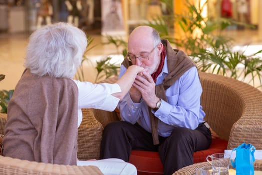 Shot of an elderly man kissing his wife on the hand