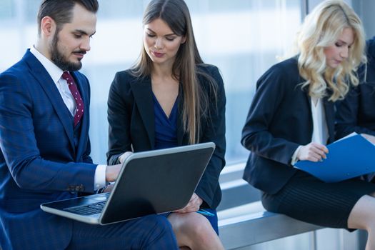 Business people working with documents on laptops at break