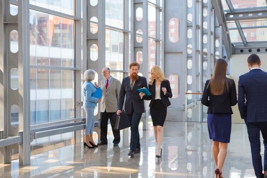 Business people walking in the lobby of a modern business center