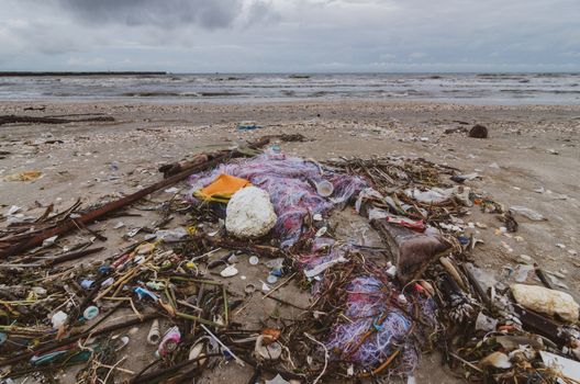 garbage the beach sea plastic bottle lies on the beach and pollutes the sea and the life of marine life Spilled garbage on the beach of the big city. Empty used dirty plastic bottles