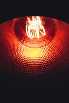 High contrast orange and red tones in a copper lamp illuminated by led light bulb