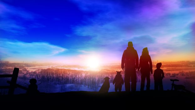 The family's silhouettes stand on a big winter slide opposite the setting sun.