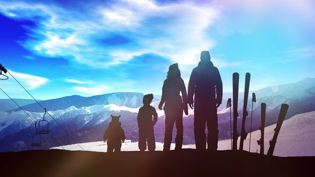 The family is standing on the ski slope opposite a bright blue sky.