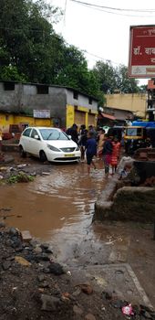 Pune, India - September 26, 2019: People roaming around when floods destroyed their homes and vehicles in India.