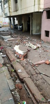 Pune, India - September 26, 2019: A wall collapsed outside a building during heavy floods in India