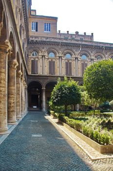 A well-kept green courtyard with trees and a fountain in the Doria Pamphili Gallery at Via del Corso, 305, Rome, Italy