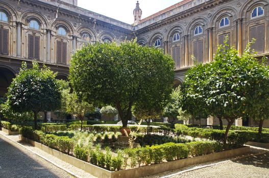 A well-kept green courtyard with trees and a fountain in the Doria Pamphili Gallery at Via del Corso, 305, Rome, Italy