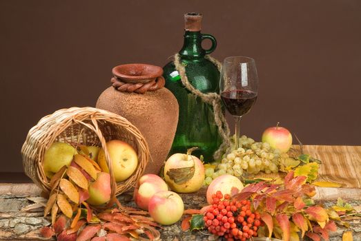 Bottle of wine and fruits on a studio background