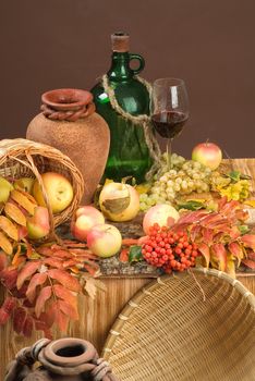Bottle of wine and fruits on a studio background