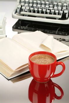 Cup of coffee, books and typewriter on a glass background