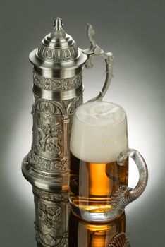 Mug of beer on a glass background