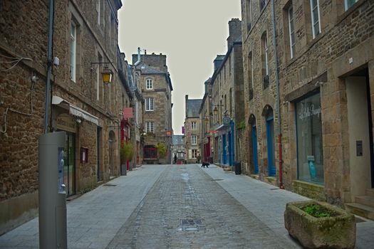 DINAN, FRANCE - April 7th 2019 - Empty street with stone building in traditional town