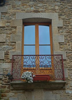 Small terrace with balcony door on old stone house