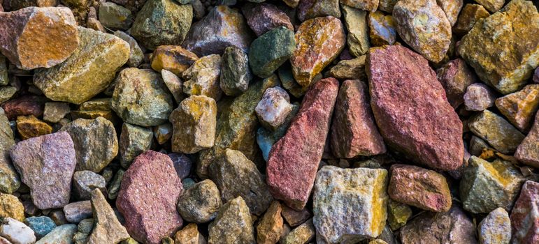 macro closeup of gravel stones in diverse colors, rock pattern background