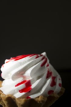 Cake Basket with cream and jam on a black background