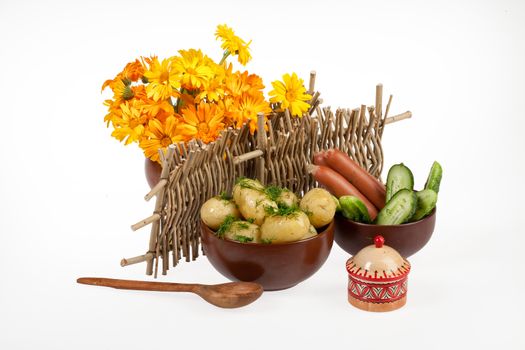 Potatoes, greenery and tableware on isolated satudio background
