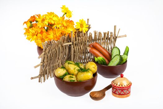 Potatoes, greenery and tableware on isolated satudio background