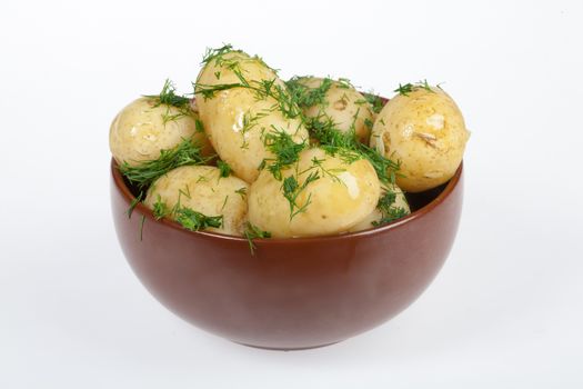 Potatoes, greenery and tableware on isolated satudio background