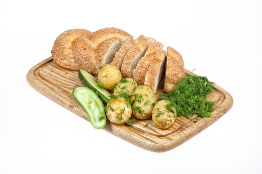 Potatoes, greenery and tableware on isolated satudio background