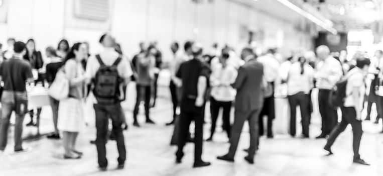 Blured image of businesspeople at coffee break at conference meeting. Business and entrepreneurship. Black and white image.
