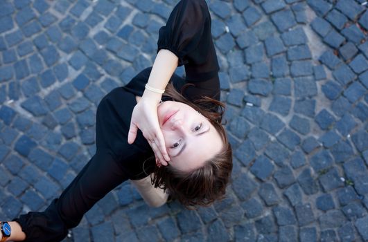 Beauty young woman against nice gray pavement background