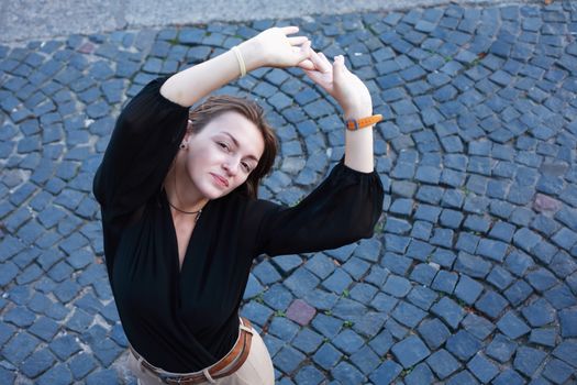 Beauty young woman against nice gray pavement background