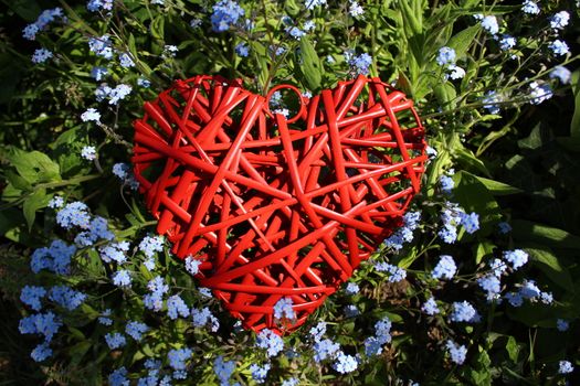 The pictureshows a red heart and spring flowers.