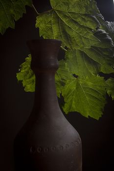 Clay bottle for wine on a black background