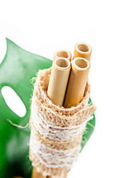 Ecological bamboo straws tube for drinking water on white background. Just say "NO" to plastic, Eco friendly concept.