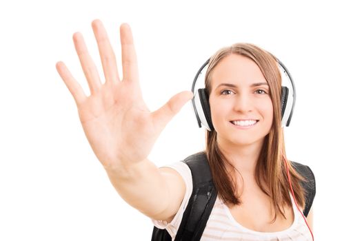 Beautiful smiling young student girl with headphones holding her hand up making a high five gesture, isolated on white background.