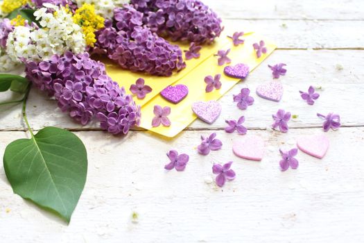 The picture shows a beautiful lilac decoration with a letter.