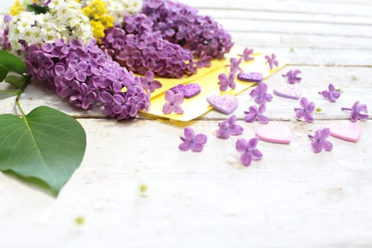 The picture shows a beautiful lilac decoration with a letter.