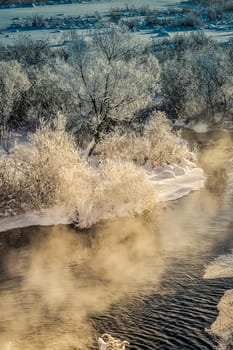 Winter sunny landscape with river and forest.