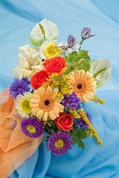 Still life with bouquet of flowers and accessories on a studio background