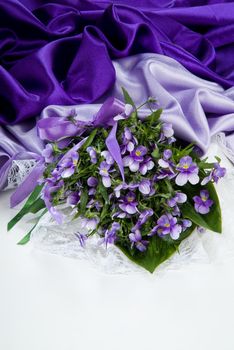 Still life with bouquet of flowers and accessories on a studio background